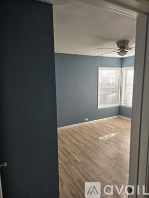San Antonio apartment for rent - A room with a ceiling fan and a window.