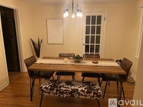 Syracuse apartment for rent - A dining room with a wooden table and chairs.