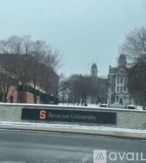 Syracuse apartment for rent - A sign for Syracuse University is in front of a building.