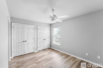 Siloam Springs apartment for rent - A kitchen with wooden cabinets and black appliances.