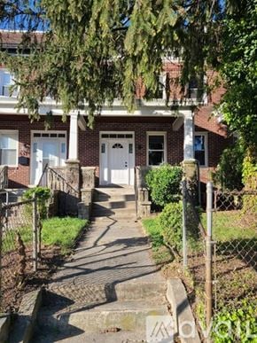 Baltimore house for rent - A house with a white door and a small porch.
