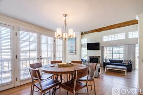 San Diego house for rent - A dining room with a wooden table and chairs.