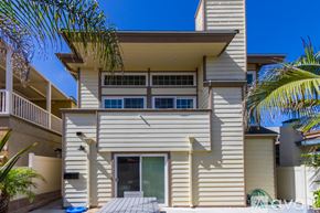 San Diego house for rent - A two-story house with a balcony and a pool.