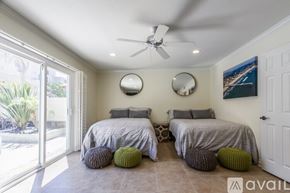 San Diego house for rent - A bedroom with two beds and a ceiling fan.