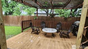 North Richland Hills apartment for rent - A wooden deck with a table and chairs under a roof.