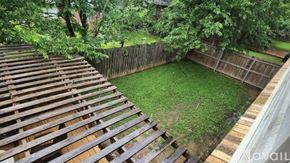 North Richland Hills apartment for rent - A backyard with a wooden deck and a fence.