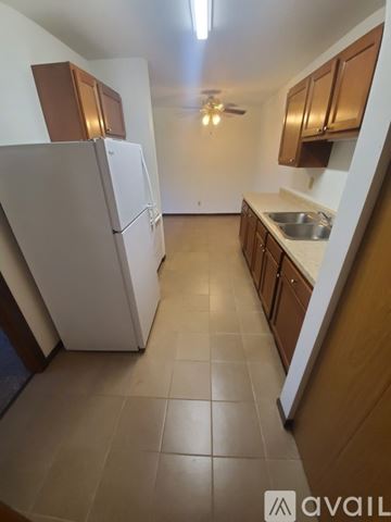 La Crosse apartment for rent - A kitchen with wooden floors and a granite counter top.