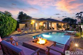 Palm Desert house for rent - A house with a pool and a fire pit in the backyard.