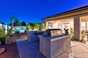Palm Desert house for rent - A house with a driveway and a hot tub in the front yard.