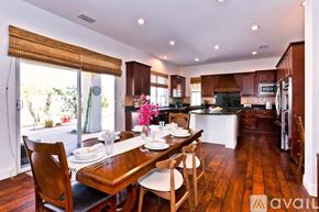 Palm Desert house for rent - A kitchen with a table set for two with chairs around it.