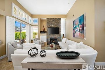 La Quinta house for rent - A living room with a fireplace and a painting on the wall.