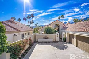 La Quinta house for rent - A sunny day in a residential area with houses and palm trees.