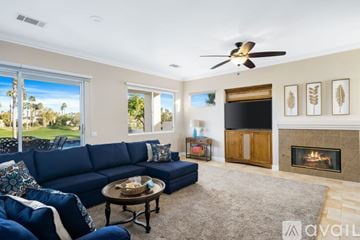 La Quinta house for rent - A living room with a blue sofa and a fireplace.