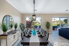 La Quinta house for rent - A dining room with a table set for six and a view of the backyard.