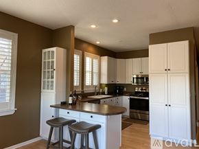 Stillwater apartment for rent - A kitchen with white cabinets and a wooden island.