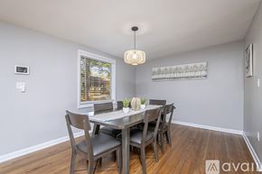 Jacksonville house for rent - A dining room with a table set for two and chairs around it.