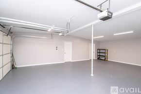 Jacksonville house for rent - A spacious room with a grey floor and white walls, featuring a white pillar, a white ceiling, and a white door.
