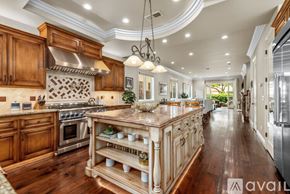 Huntington Beach house for rent - A kitchen with wooden cabinets and a large island in the middle.