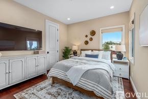 Huntington Beach house for rent - A bedroom with a large bed and a television.