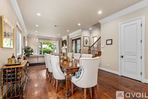 Huntington Beach house for rent - A dining room with a wooden table and chairs.