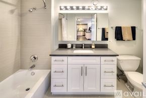 Chicago condo for rent - A modern bathroom with a white tub and sink.