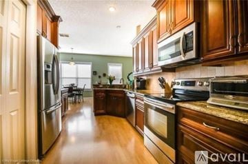 Apopka apartment for rent - A kitchen with wooden cabinets and stainless steel appliances.