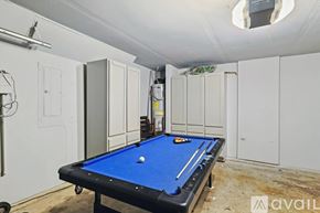 Grand Prairie house for rent - A pool table in a room with white cupboards.