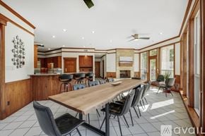 Garland house for rent - A long wooden table is surrounded by black chairs in a spacious room with a bar area in the background.