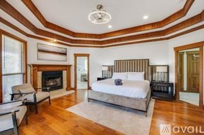 Garland house for rent - A bedroom with a large bed and a fireplace.