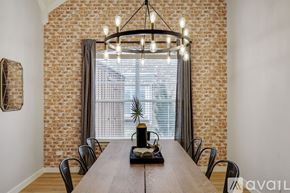 Haltom City house for rent - A dining room with a wooden table and chairs.