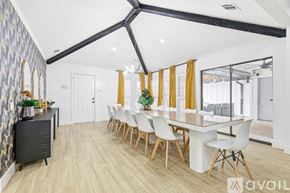 Plano house for rent - A modern dining room with a long table and chairs.