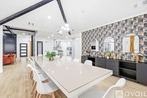 Plano house for rent - A modern kitchen with a stone backsplash and wooden flooring.