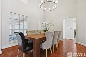 Rockwall house for rent - A dining room with a wooden table and chairs.