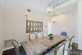 Rowlett house for rent - A dining room with a wooden table and chairs.