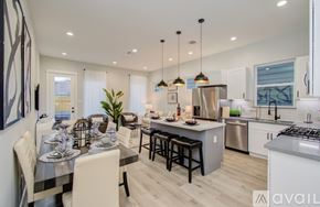 Houston house for rent - A modern kitchen with a dining table set for two.