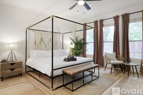 Highland Village house for rent - A bedroom with a four poster bed and a chair.