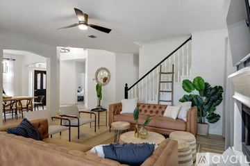Highland Village house for rent - A living room with a brown couch and a ceiling fan.