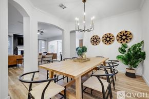 Highland Village house for rent - A dining room with a wooden table and chairs.