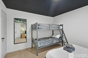 Saginaw house for rent - A bedroom with a bunk bed and a ladder.