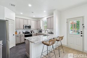 Saginaw house for rent - A kitchen with a marble countertop and modern appliances.