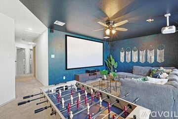 Saginaw house for rent - A foosball table is in the middle of a living room.