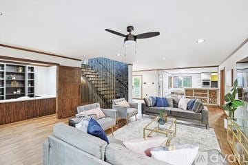 Mckinney house for rent - A living room with a grey couch and a wooden wall.
