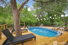 Lancaster house for rent - A pool surrounded by trees and deck chairs.