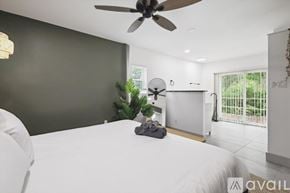 Lancaster house for rent - A bedroom with a white bed and a ceiling fan.