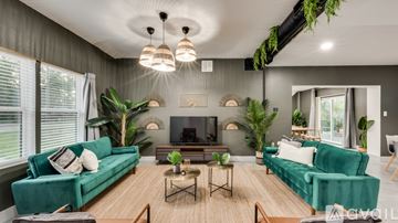 Lancaster house for rent - A living room with a green couch and a wooden floor.