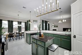 Waxahachie house for rent - A kitchen with green cabinets and a black and white checkered floor.