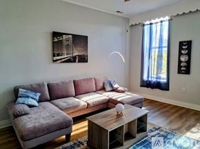 Chicago apartment for rent - A living room with a grey couch, a coffee table, and a painting on the wall.