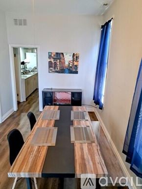 Chicago apartment for rent - A dining room with a wooden table and chairs.