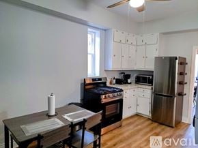 Chicago apartment for rent - A kitchen with a table and chairs in front of it.