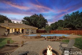 Desoto house for rent - A backyard with a fire pit and a pool.